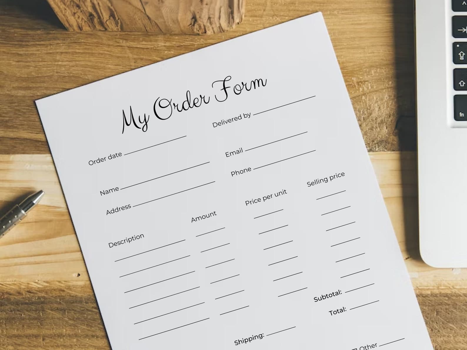 Editable Canva order form template on a desk with pen and laptop